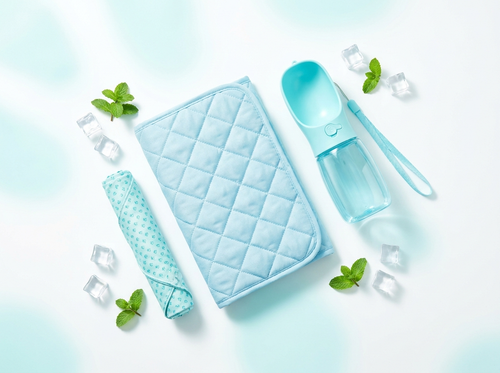 Summer pet comfort bundle: cooling mat, bandana and water bottle flat lay
